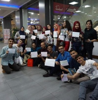 Students showing their completion certificates.