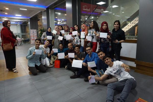 Students showing their completion certificates.