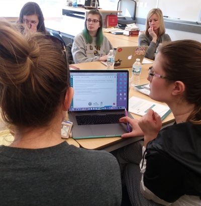 students in front of laptop