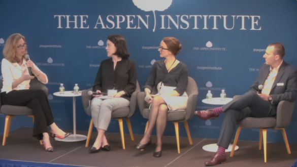 Two people sitting in chairs on a stage in the Aspen Institute at Washington D.C.