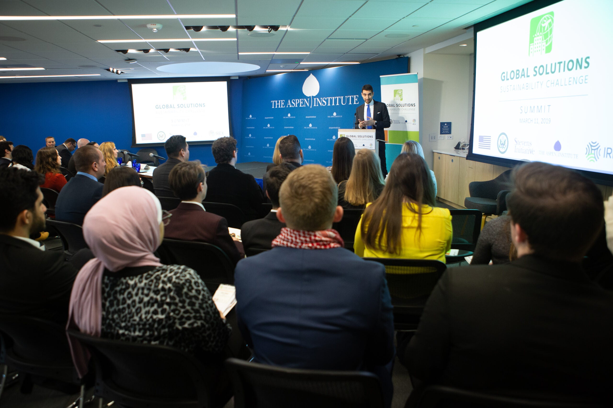 A speaker addressing a crowd inside the Aspen Institute at Washington D.C.