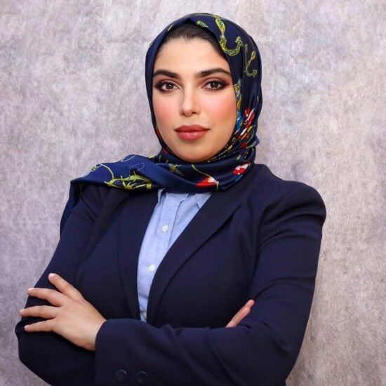 Image of woman standing with her arms crossed