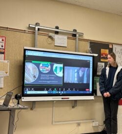 Three students, Eleanor, Raad, and Yazn participating in a presentation