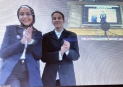 Two students standing in front of a screen, Yasmine and Tasneem