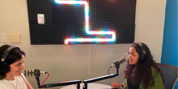 Two women recording a podcast