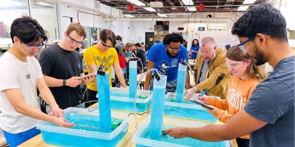 A group of students in a science lab working with engineering kits