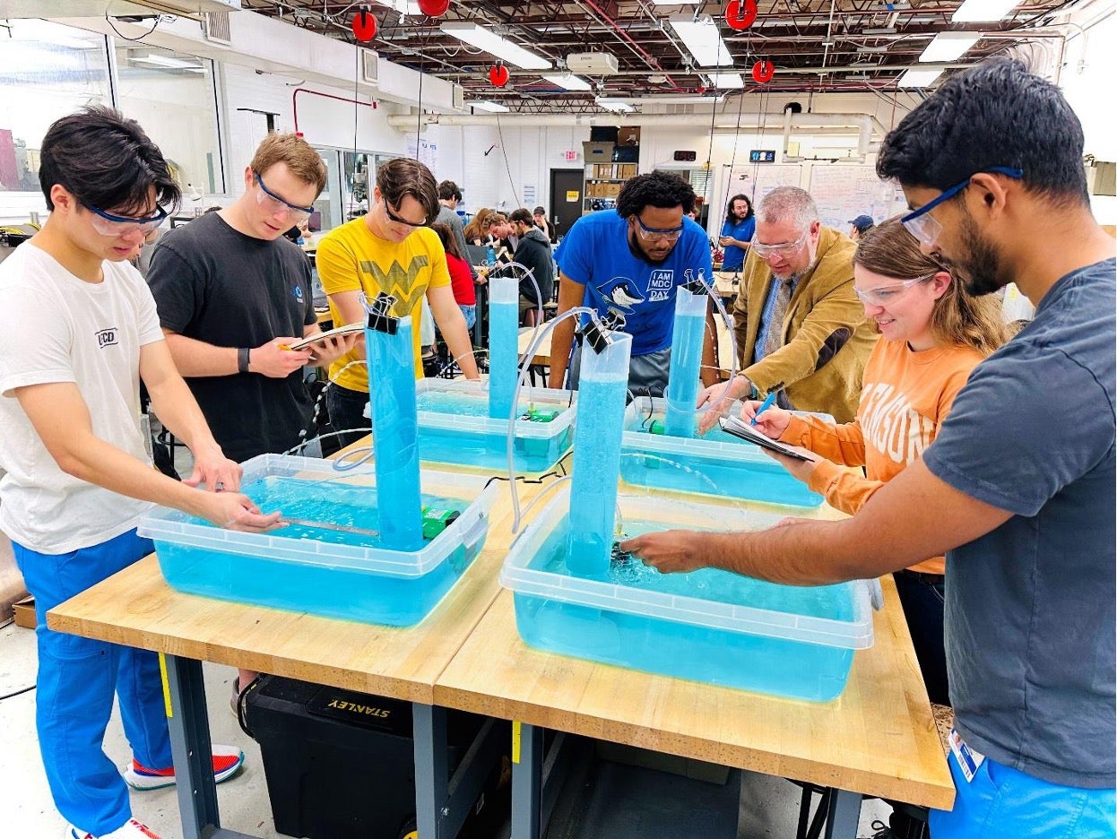 A group of students in a science lab working with engineering kits