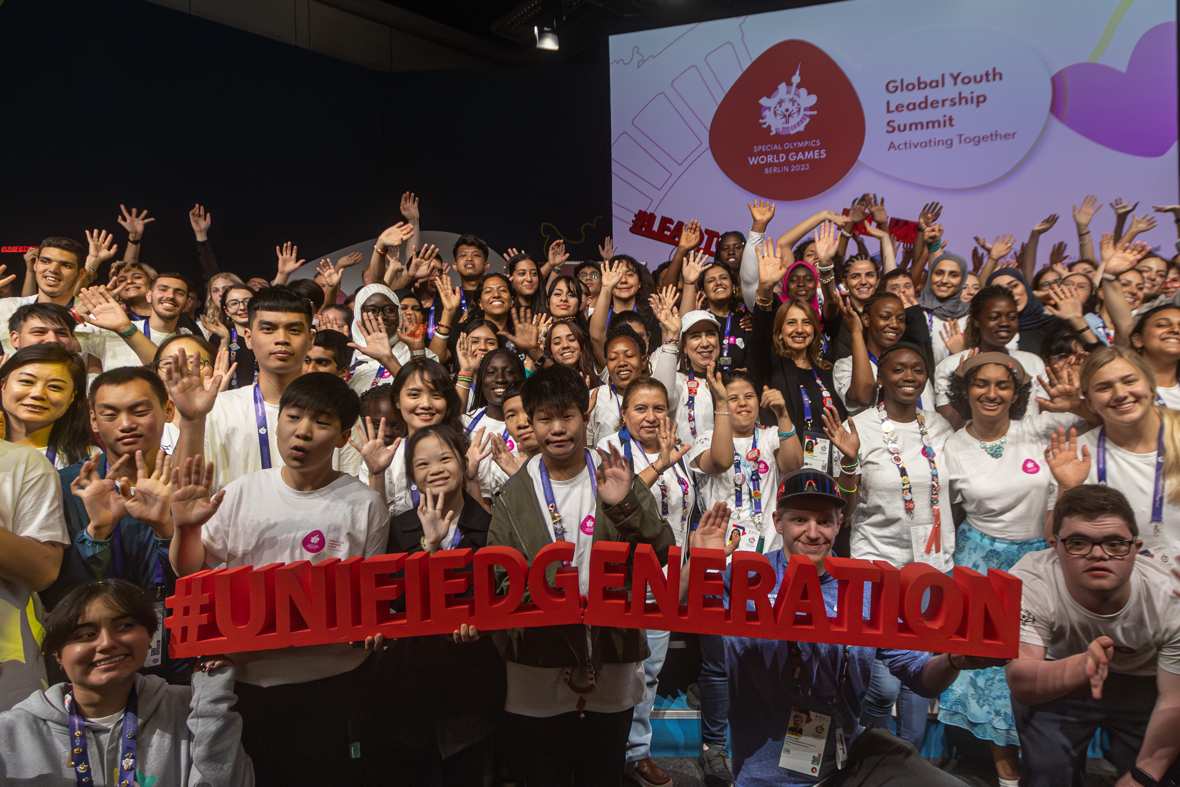 A group of young people with a special olympics sign.